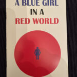 A BLUE GIRL IN A READ WORLD